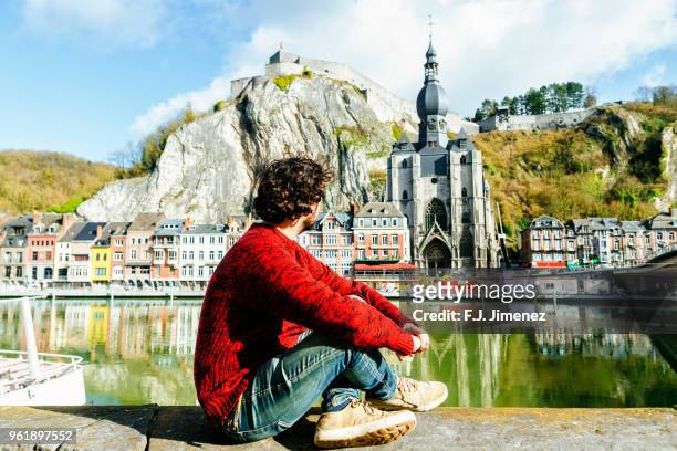 man looking towards dinant village in belgium - belgium stock-fotos und bilder