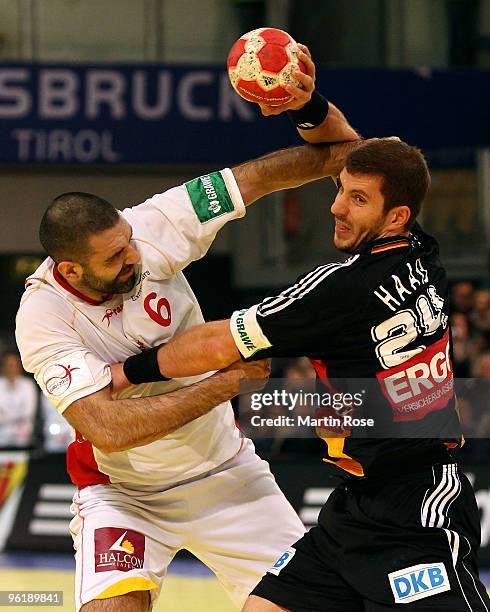 Michael Haass of Germany is challenged by Ruben Garabaya of Spain during the Men's Handball European main round Group II match between Germany and...