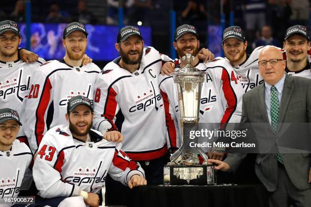 The Washington Capitals and NHL Deputy Commissioner Bill Daly pose with the Prince of Wales Trophy after defeating the Tampa Bay Lightning in Game...