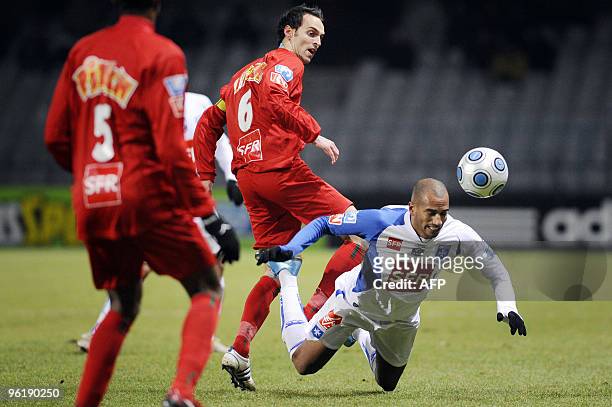 Auxerre's French forward Aurelien Capoue is tackled by Sedan's French middfielder Jerome Lemoigne on January 26, 2010 at the Abbe Deschamps stadium...