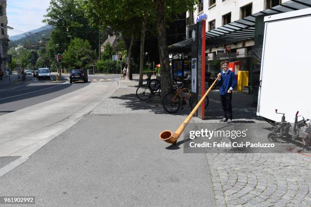 a young swiss alphorn player at old town of biel, switzerland - alphorn stock-fotos und bilder