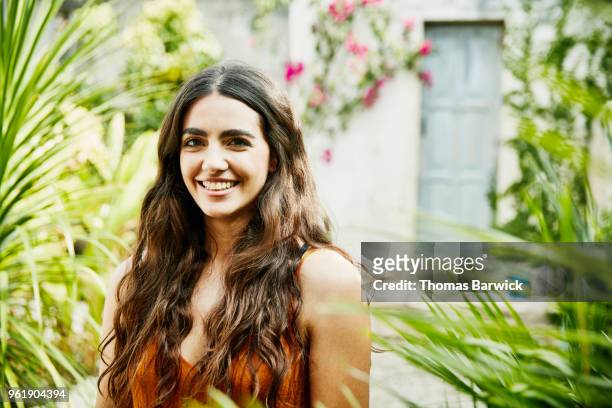 Portrait of smiling woman standing in courtyard of outdoor spa