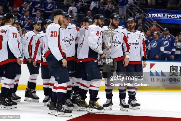 Alex Ovechkin of the Washington Capitals celebrates with his teammates and the Prince of Wales Trophy after defeating the Tampa Bay Lightning in Game...