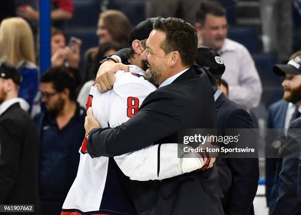 Washington Capitals professional development coach Olie Kolzig embraces Washington Capitals left wing Alex Ovechkin after the seventh game of the NHL...