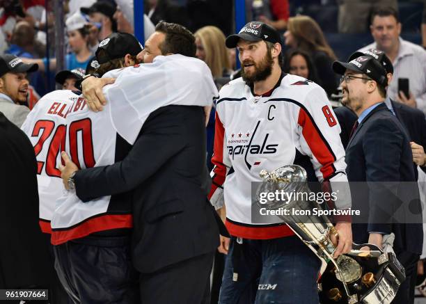 Washington Capitals professional development coach Olie Kolzig embraces Washington Capitals goalie Braden Holtby as Washington Capitals left wing...