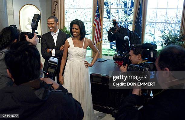 Photographers take pictures of wax figures of US President Barak Obama and First Lady Michelle Obama are on display January 26, 2010 at Madame...