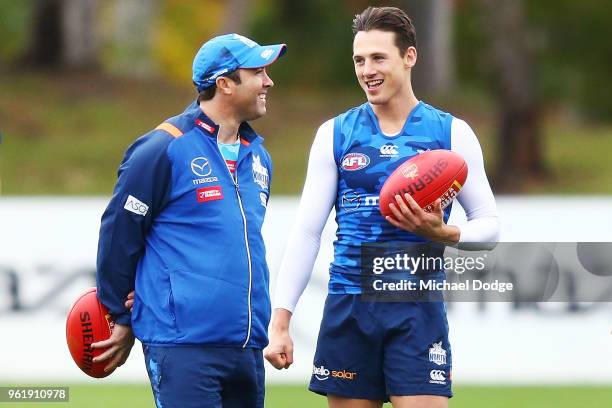 Kangaroos head coach Brad Scott talks to Ben Jacobs of the Kangaroos during the North Melbourne Kangaroos AFL training session at Arden Street Ground...