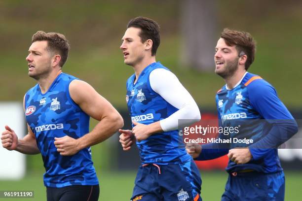 Shaun Higgins of the Kangaroos and Ben Jacobs warm up during the North Melbourne Kangaroos AFL training session at Arden Street Ground on May 24,...