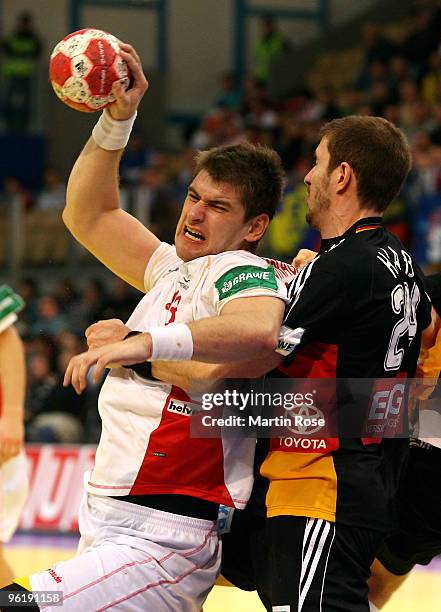 Michael Haas of Germany challenges Julen Aguinagalde of Spain during the Men's Handball European main round Group II match between Germany and Spain...