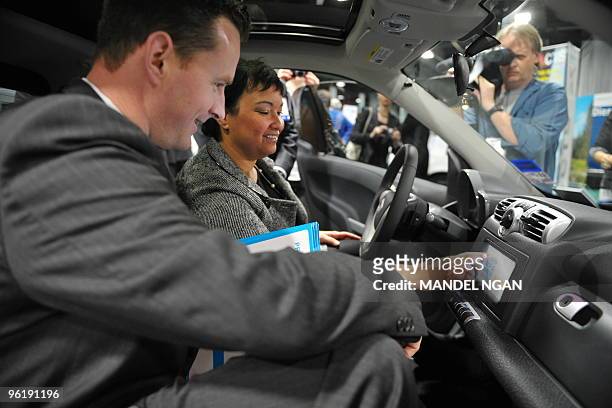 Administrator Lisa Jackson enters a PIN number into the console of the a car2go on-demand fuel efficient rental vehicle with the help of car2go...