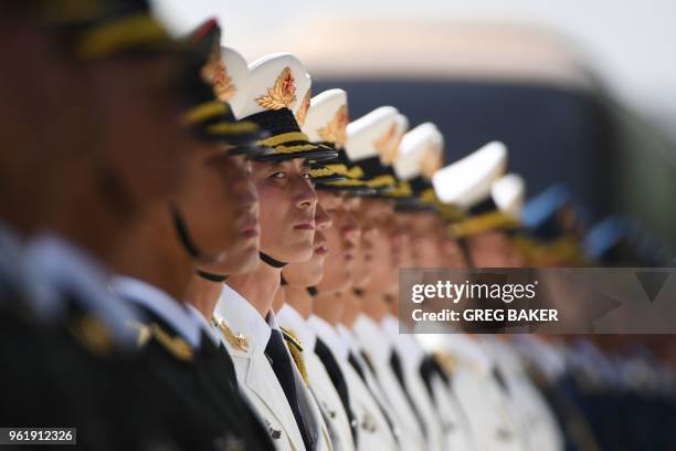 Members of a military honour guard practice before a welcome ceremony for German Chancellor Angela Merkel outside the Great Hall of the People in...