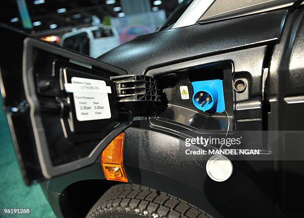 An electrical outlet connection is seen on the side of the Think City electric car January 26, 2010 at the Washington Auto Show at the Walter E...