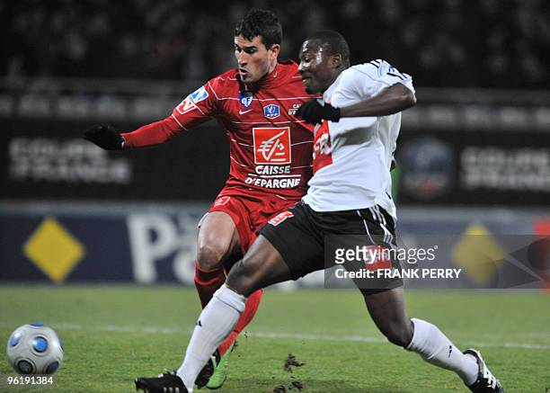 Vannes' s forward Franck Djadjedje vies with Grenoble's forward Jean Calve to score during their French football cup 1/16 final match Vannes vs...