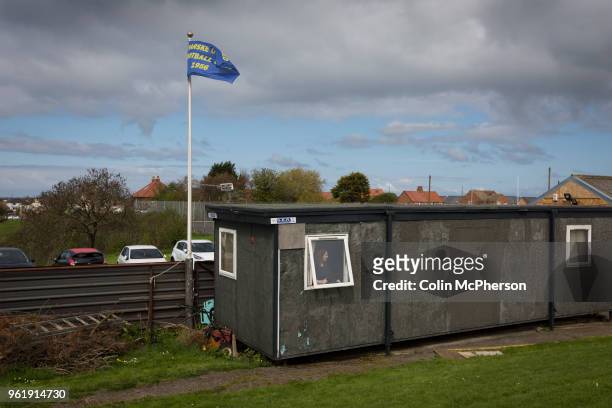 Woman opens a window in a portable containers at Mount Pleasant before Marske United take on Billingham Synthonia in a Northern League division one...
