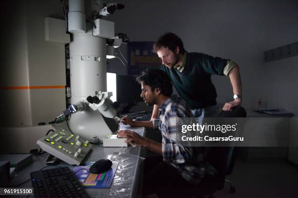 scientists using field emission electron microscope - scanning electron microscope stock pictures, royalty-free photos & images