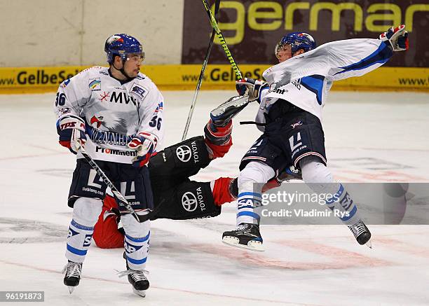 Christoph Ullmann of Haie and Marcus Kink of Adler clash as Adler's Yannic Seidenberg looks on during the DEL game between Koelner Haie and Adler...