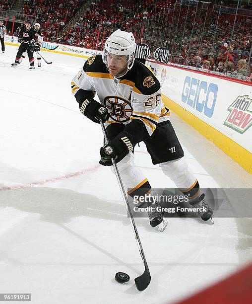 Mark Recchi of the Boston Bruins carries the puck along the boards during a NHL game against the Carolina Hurricanes on January 24, 2010 at RBC...