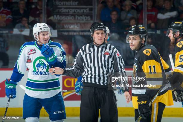 Linesman stands between Colby Sissons of Swift Current Broncos as he gets in the face of Justin Lemcke of Hamilton Bulldogs at Brandt Centre - Evraz...