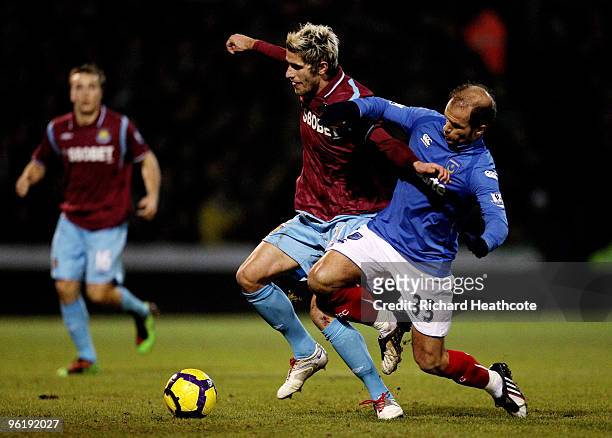 Valon Behrami of West Ham holds off Angelos Basinas of Pomey during the Barclays Premier League match between Portsmouth and West Ham United at...