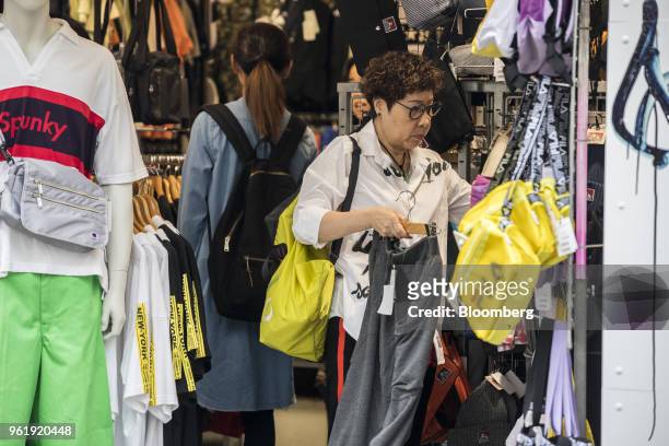 Shoppers browse a store on Takeshita Street in the Harajuku area of Tokyo, Japan, on Wednesday, May 23, 2018. Japan stocks led declines in most Asian...