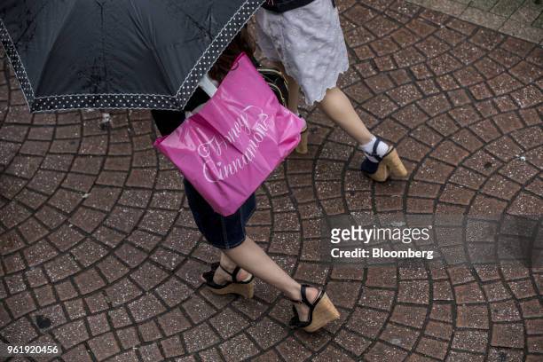 Shoppers walk along Takeshita Street in the Harajuku area of Tokyo, Japan, on Wednesday, May 23, 2018. Japan stocks led declines in most Asian...