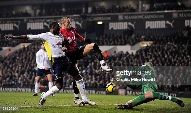 Heurelho Gomes of Spurs rushes out to claim the ball as Ledley King of Spurs tussles with Bobby Zamora of Fulham during the Barclays Premier League...