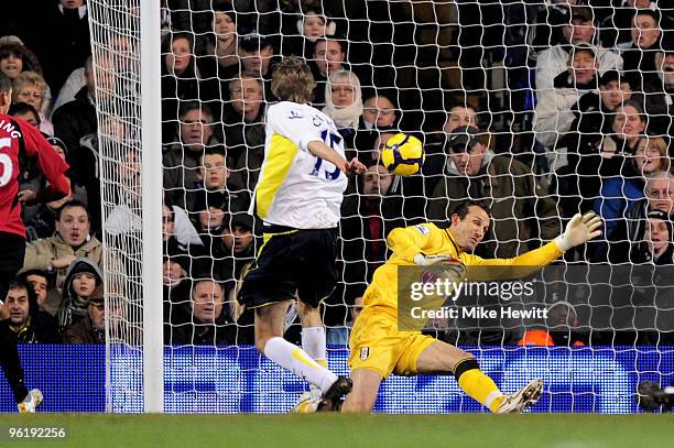 Peter Crouch of Spurs scores the opening goal past Mark Schwarzer of Fulham during the Barclays Premier League match between Tottenham Hotspur and...