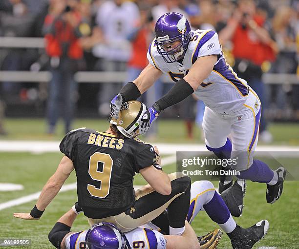 Drew Brees of the New Orleans Saints is hit after the throw by Ben Leber and Jared Allen of the Minnesota Vikings during the NFC Championship Game on...