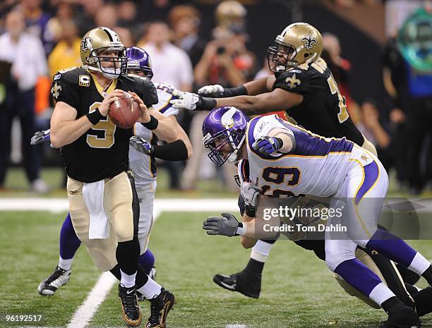 Drew Brees of the New Orleans Saints passes under pressure from Jared Allen of the Minnesota Vikings during the NFC Championship Game on January 24,...