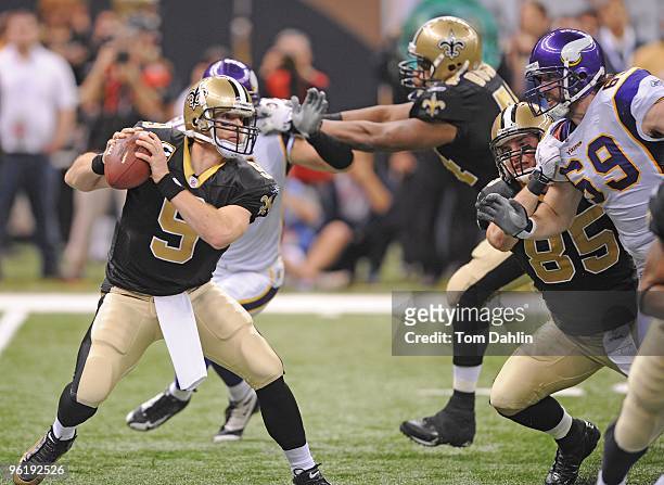 Drew Brees of the New Orleans Saints passes under pressure from Jared Allen of the Minnesota Vikings during the NFC Championship Game on January 24,...