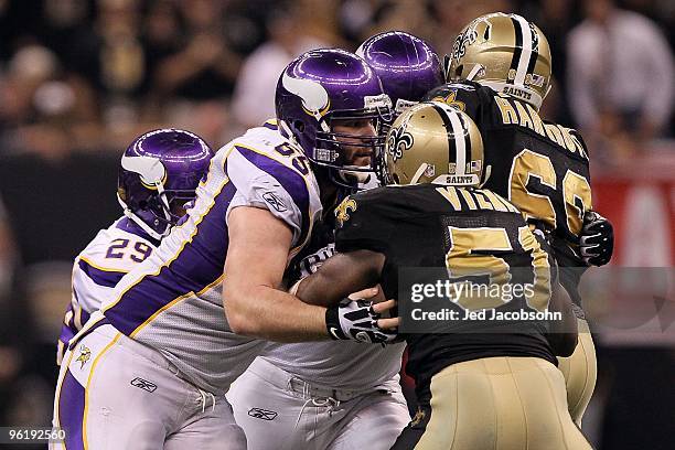 John Sullivan of the Minnesota Vikings runs blocks against Jonathan Vilma of the New Orleans Saints during the NFC Championship Game at the Louisiana...