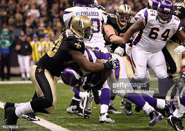 Adrian Peterson of the Minnesota Vikings scores a 2-yard rushing touchdown in the fourth quarter against Marvin Mitchell of the New Orleans Saints...