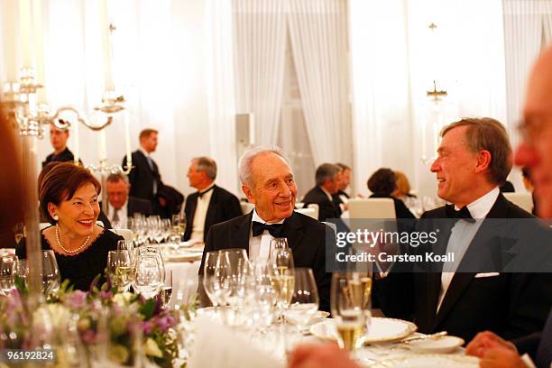 German President Horst Koehler gestures during a gala dinner in honour to Israeli President Shimon Peres on January 26, 2010 in Berlin, Germany....