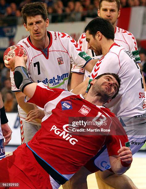 Bartosz Jurecki of Poland is challenged by Daniel Kubes and Jiri Vitek of Czech Republic during the Men's Handball European main round Group II match...