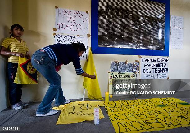 Fan of Mexican football team America lights a candle in support of Paraguayan footballer Salvador Cabanas at the Azteca Stadium in Mexico City on...