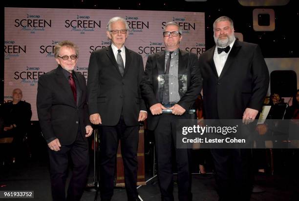 President Paul Williams, Composers Bruce Broughton, John Powell and Director Dean DeBlois pose with the Henry Mancini Award onstage at the 33rd...