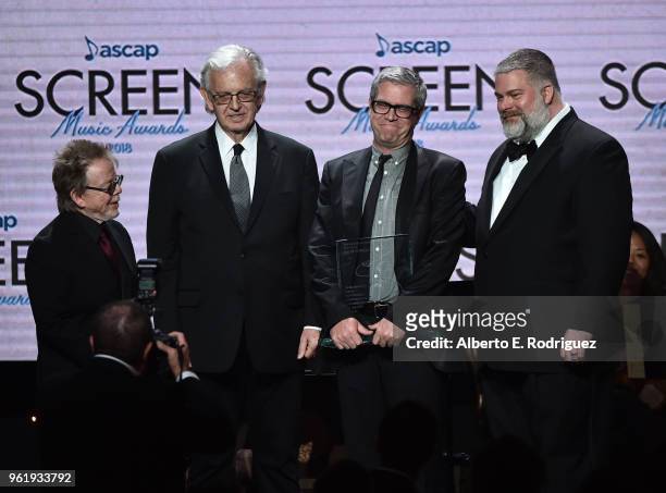 President Paul Williams, Composers Bruce Broughton, John Powell and Director Dean DeBlois pose with the Henry Mancini Award onstage at the 33rd...