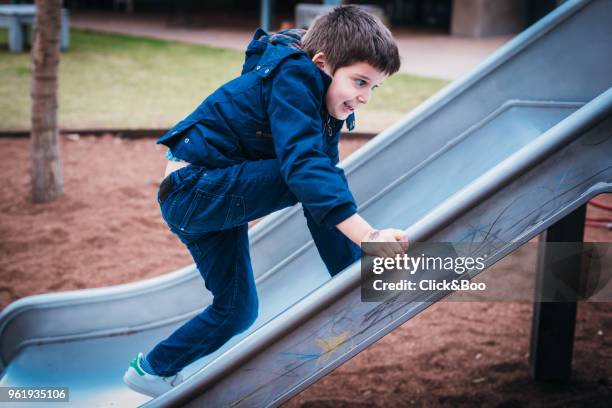 child on a slide - click&boo stock pictures, royalty-free photos & images