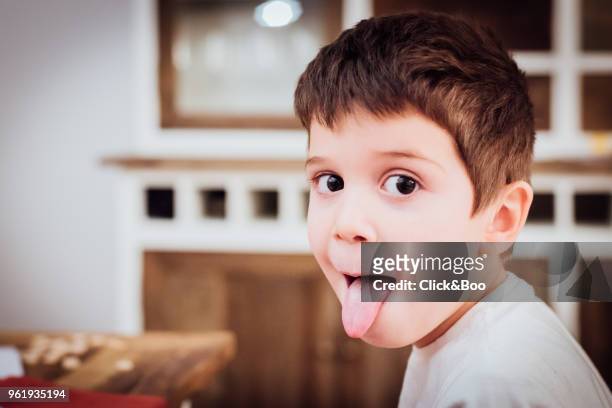 cute little boy sticking out tongue (indoors) - click&boo stock pictures, royalty-free photos & images