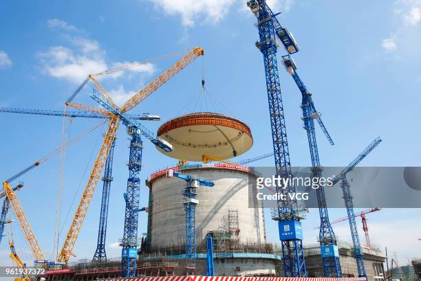 The dome is hoisted onto the reactor building at the construction site of the Fangchenggang Nuclear Power Plant Unit 3 on May 23, 2018 in Fangcheng,...