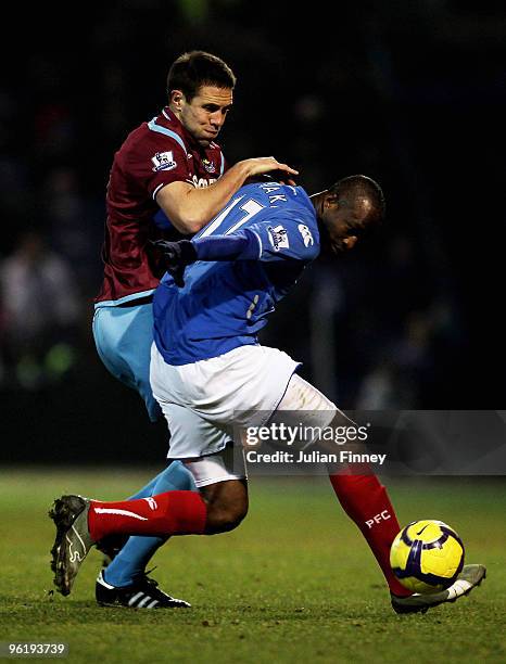 Matthew Upson of West Ham battles with John Utaka of Portsmouth during the Barclays Premier League match between Portsmouth and West Ham United at...