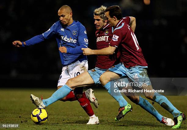 Valon Behrami of West Ham holds off Danny Webber of Pompey during the Barclays Premier League match between Portsmouth and West Ham United at Fratton...