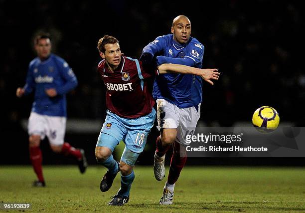 Anthony Vanden Borre of Pompey and Jonathan Spector of West Ham battle for the ball during the Barclays Premier League match between Portsmouth and...