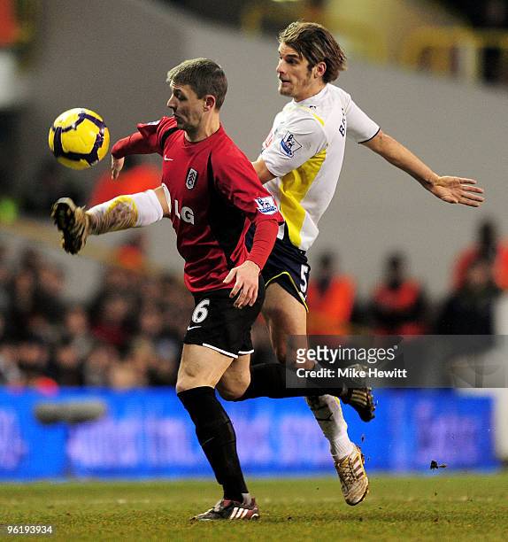 David Bentley of Spurs plays the ball upfield past Chris Baird of Fulham during the Barclays Premier League match between Tottenham Hotspur and...