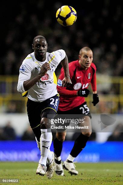 Ledley King of Spurs and Bobby Zamora of Fulham chase down the loose ball during the Barclays Premier League match between Tottenham Hotspur and...