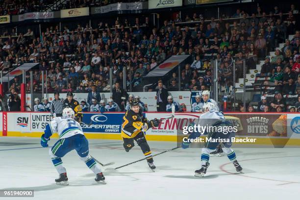 Robert Thomas of Hamilton Bulldogs takes a slap shot between Colby Sissons and Artyom Minulin of Swift Current Broncos at Brandt Centre - Evraz Place...