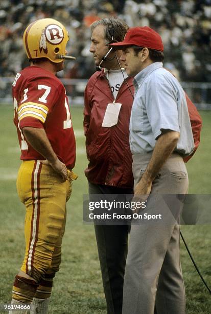 S: Coach George Allen of the Washington Redskins talks with his quarterback Billy Kilmer from the sideline during a circa 1970s NFL game at RFK...