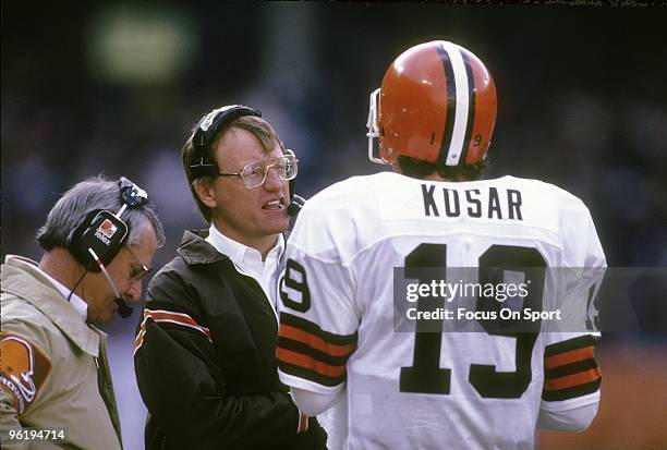 S: Head Coach Marty Schottenheimer of the Cleveland Browns talks with his quarterback Bernie Kosar on the sidelines during a mid circa 1980's NFL...