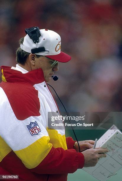 S: Head Coach Marty Schottenheimer of the Kansas City Chiefs going over his game plan on the sidelines during a mid circa 1990's NFL football game at...