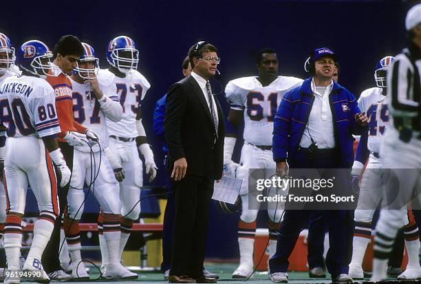 Denver Broncos Head Coach Dan Reeves with his game plan in hand, watches the action from the sideline during a mid circa 1980;s NFL football game....